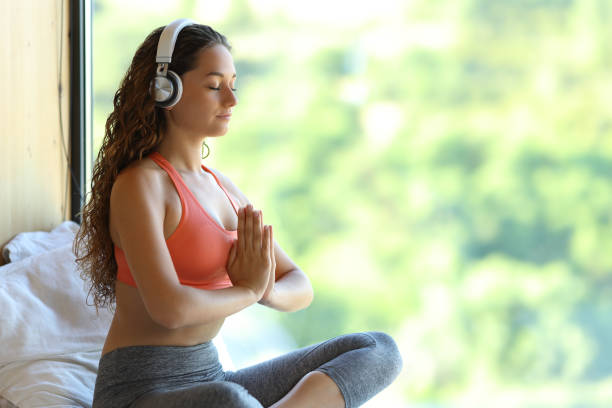 Yogi with headphones listening yoga audio guide